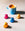 Four coloured Mozzo coffee pods next to a full cup of coffee