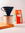 A coffee mug with a V60 filter and bag of Mozzo filter coffee