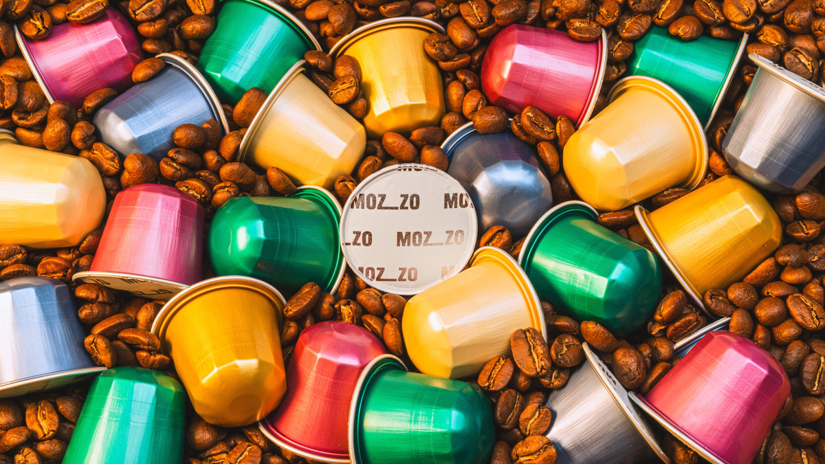 Mozzo coffee pods amongst a pile of coffee beans