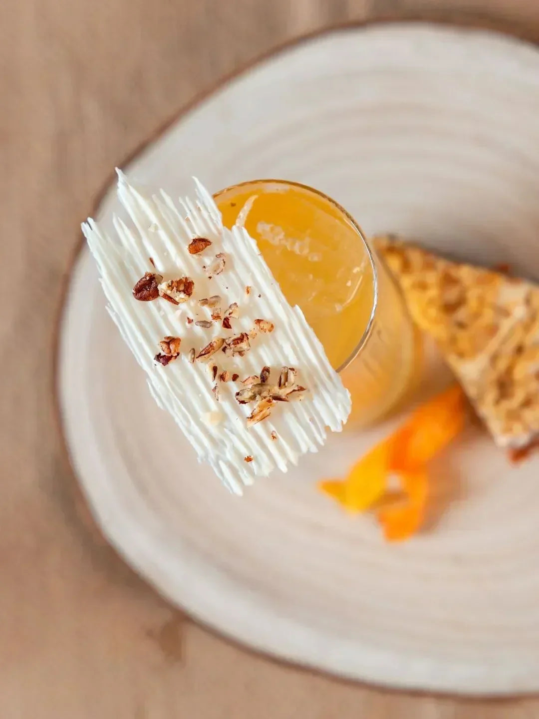 A coffee and carrot cake cocktail with a carrot cake next to it