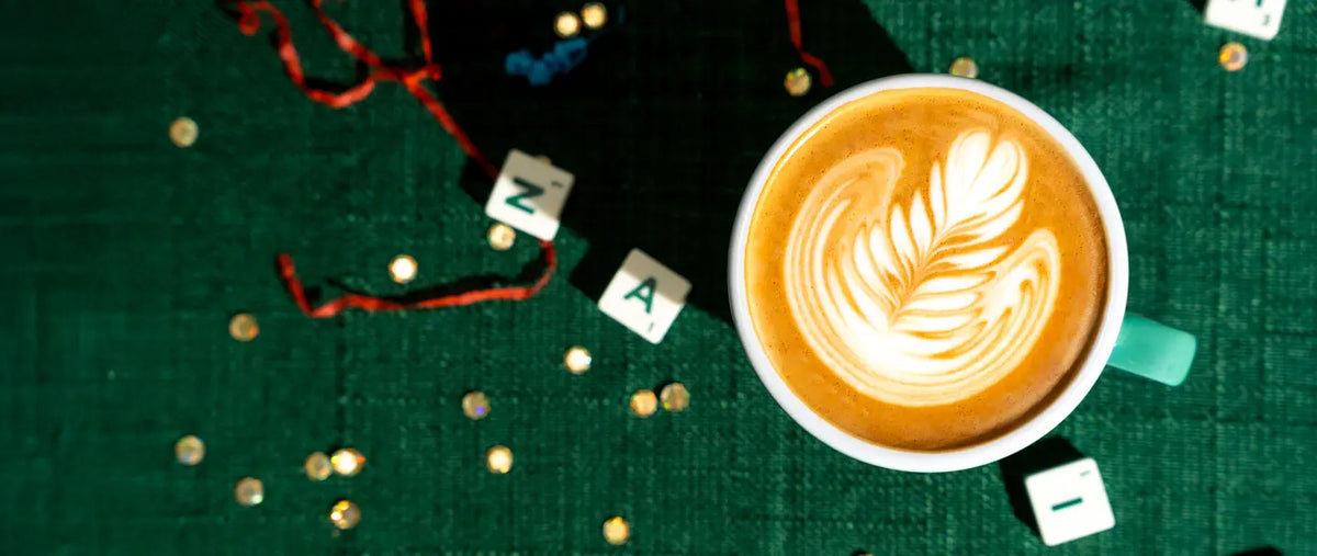 Top down of a latte on a Christmas table with Scrabble letters