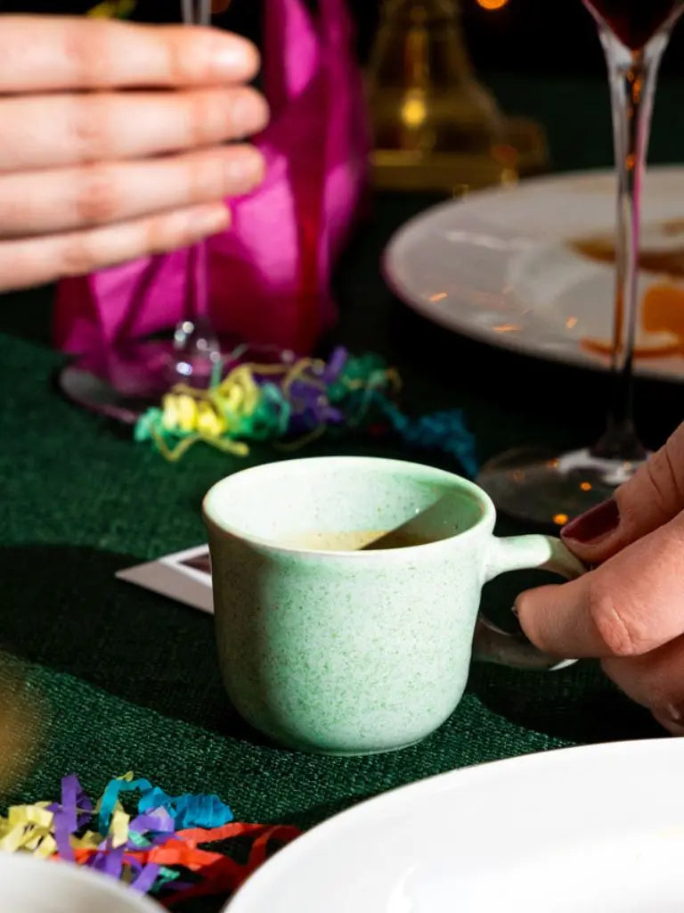 Espresso on a table with colourful ribbons and a blurred background